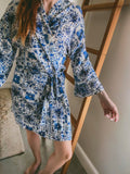 Women wearing a blue Moroccan tile print kimono wrap gown made from Ecovero Viscose Linen.
