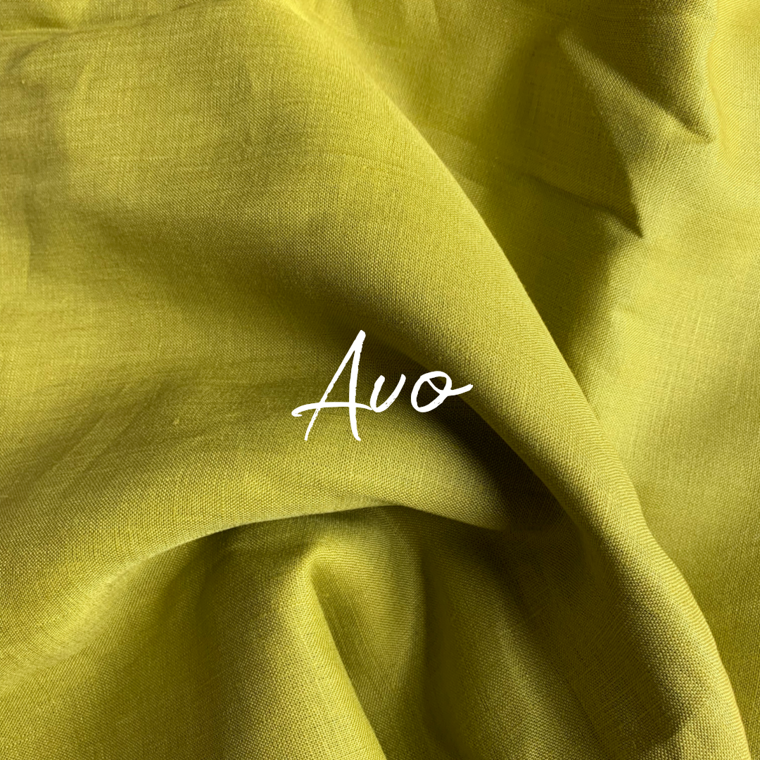 Close-up of green pure linen fabric with 'Avo' branding the shade of colour.