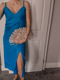 Women wearing a bias cut slip linen dress with knee slit.