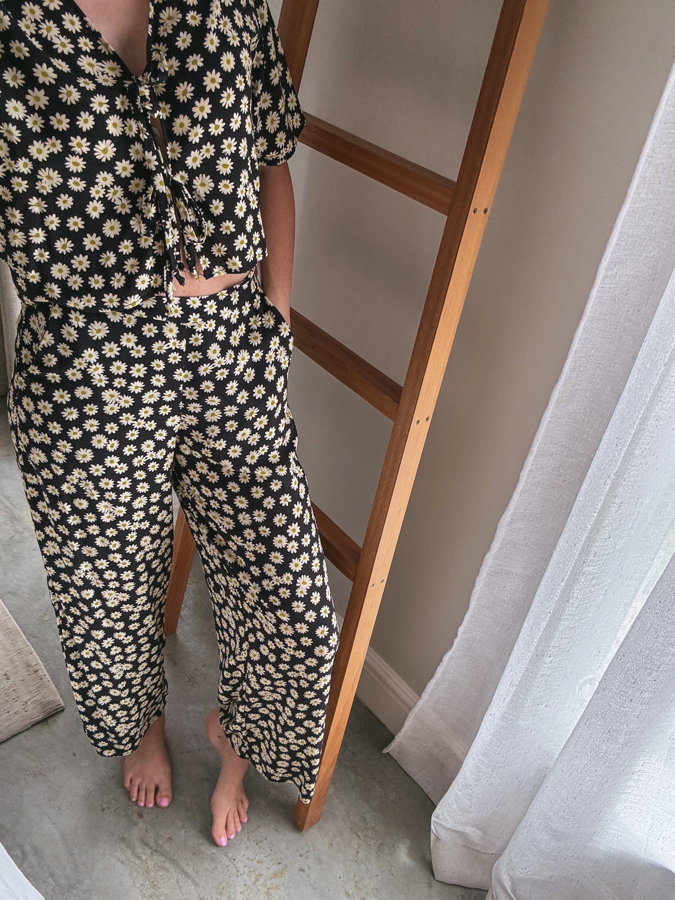 Person wearing a daisy print set made from Ecovero Viscose.