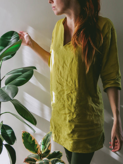 Women in pure linen chartreuse green colour kaftan with V-slit neckline and 3/4 sleeves with cuff.