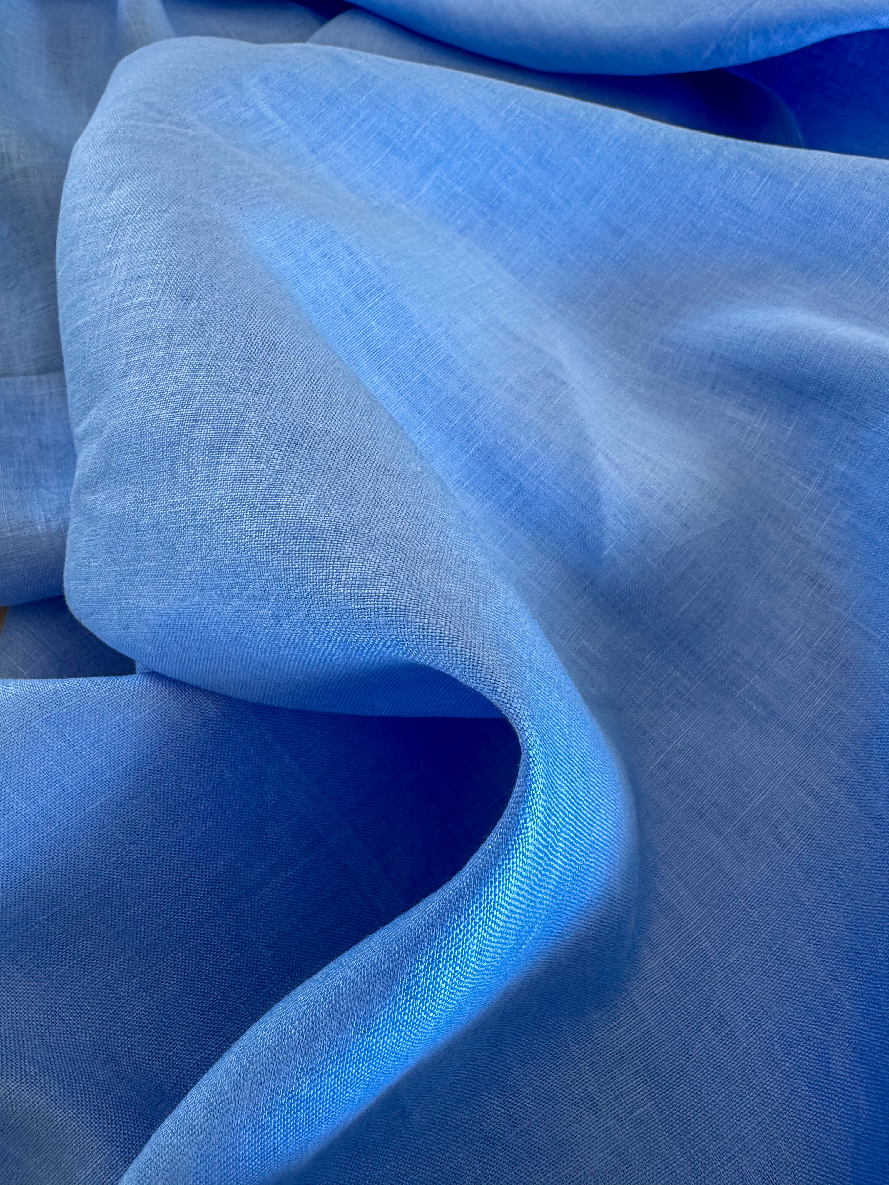 Close-up of marina blue pure linen fabric with a textured surface.
