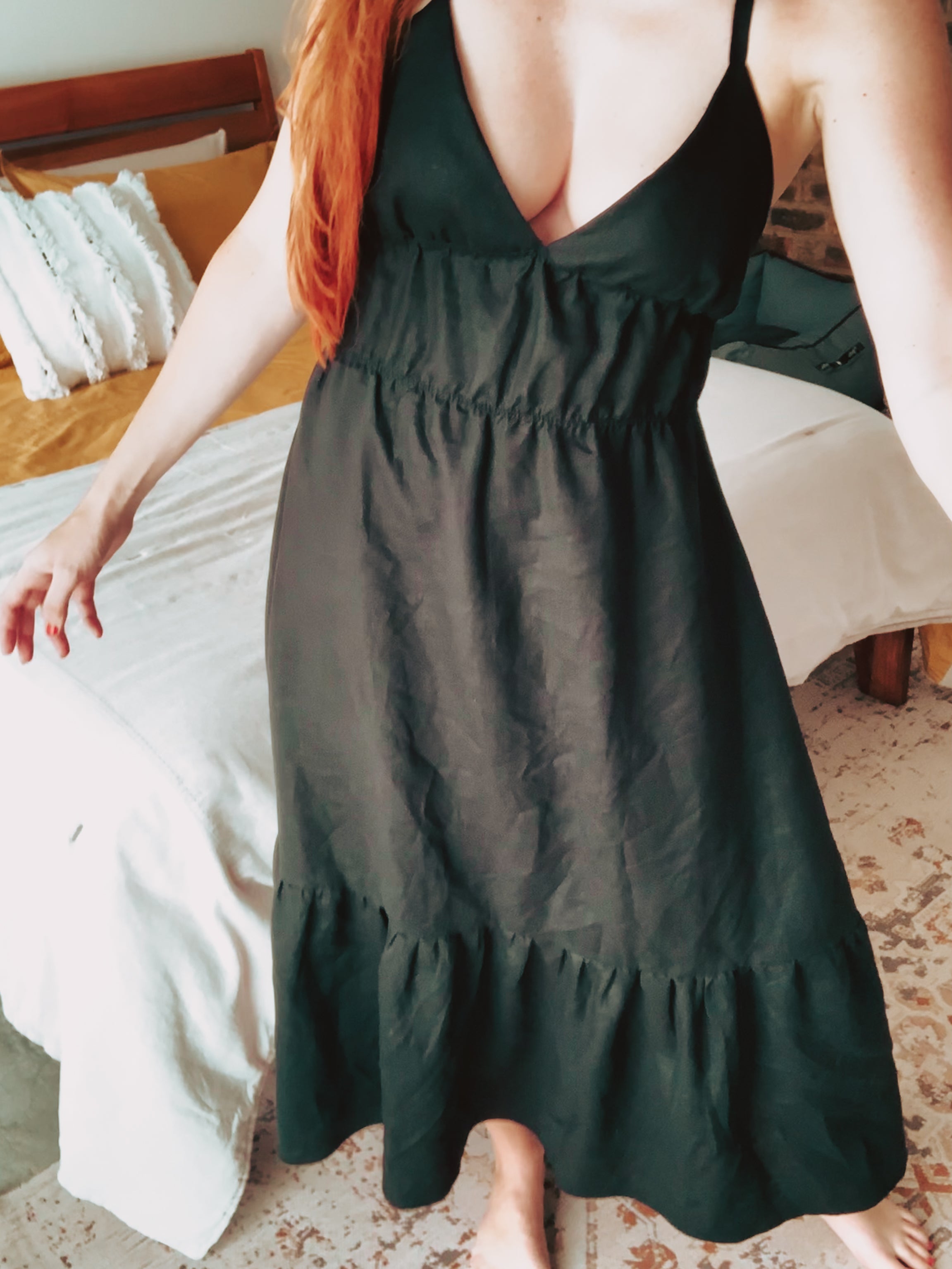 Person wearing a pure linen black maxi dress with tiered sections.