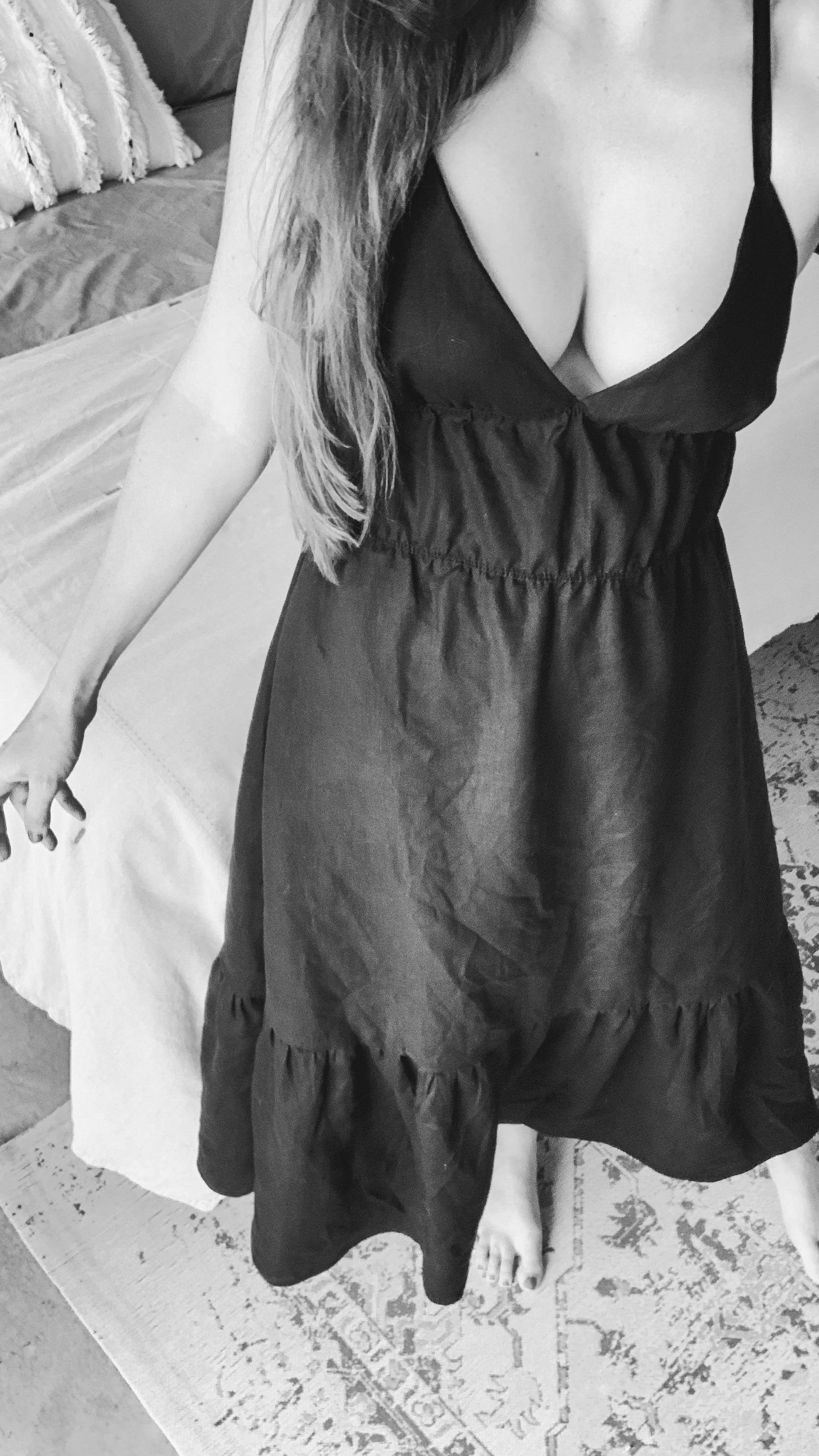 Close up of person wearing a black linen maxi dress.