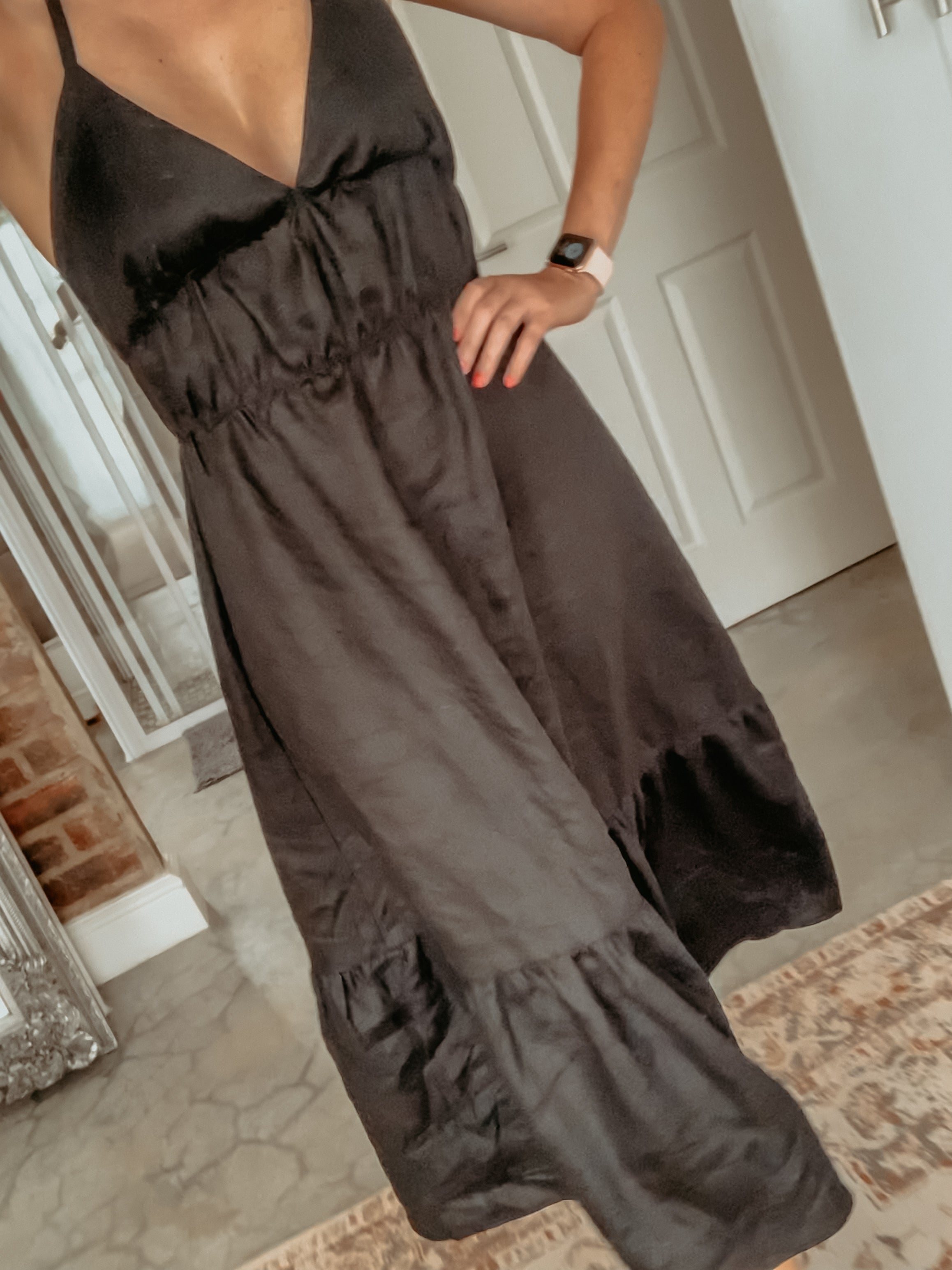 Front view of person walking and wearing a linen maxi dress.