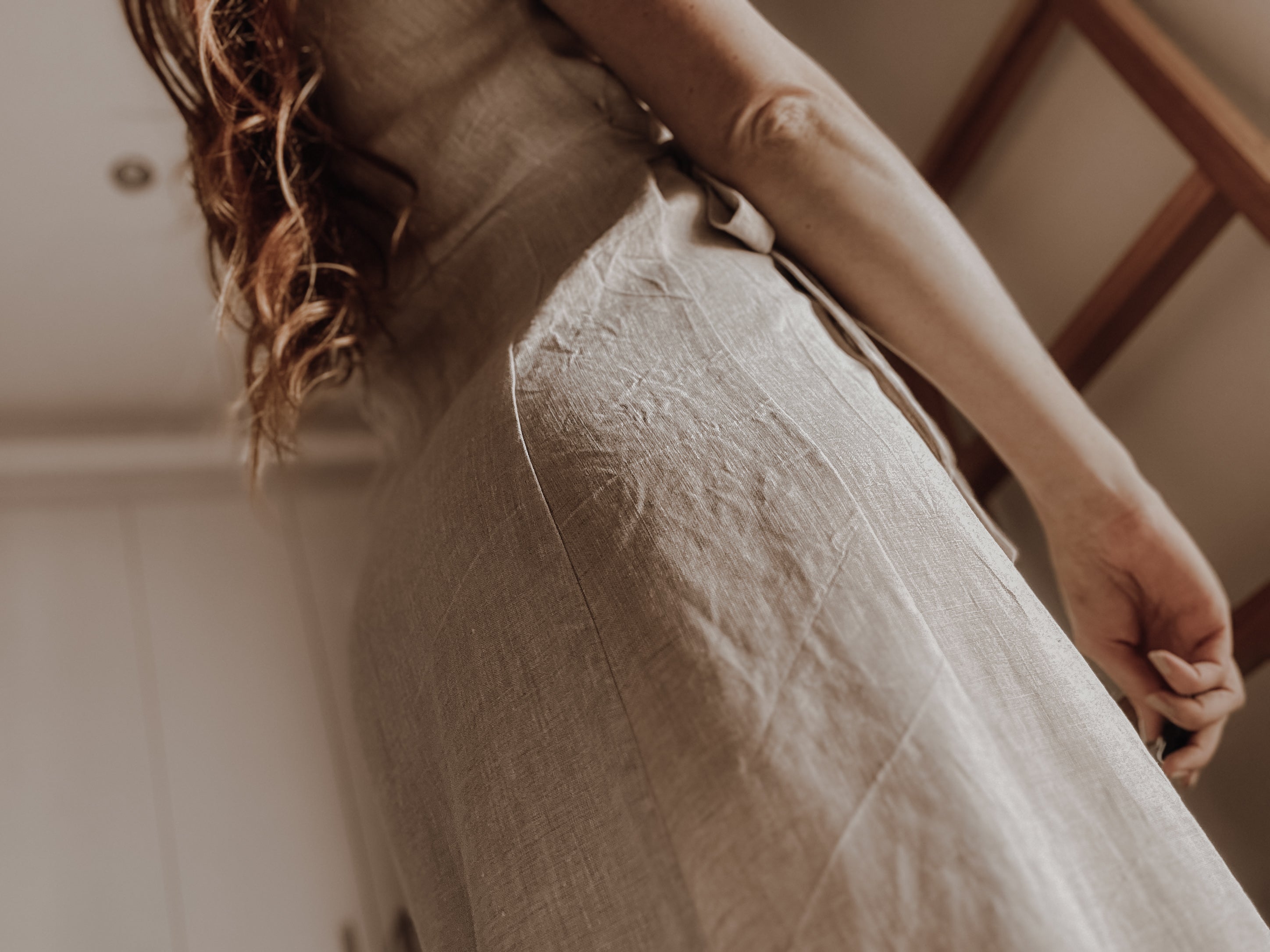 Back side panel view of natural colour linen dress.