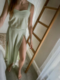 Woman wearing a light green matching set made from Ecovero viscose linen.