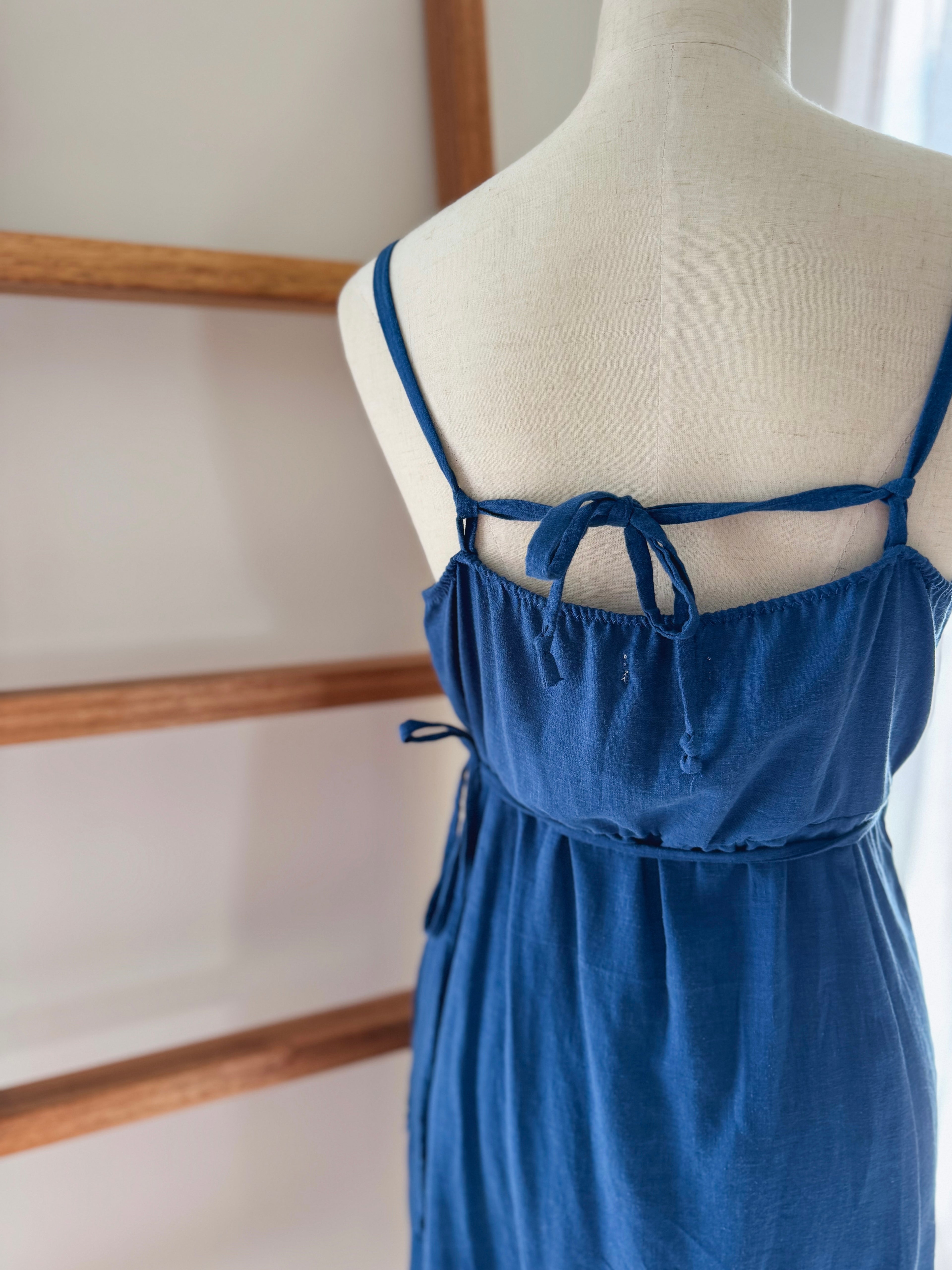Blue dress on a mannequin showcasing another option of tying the adjustable straps. 